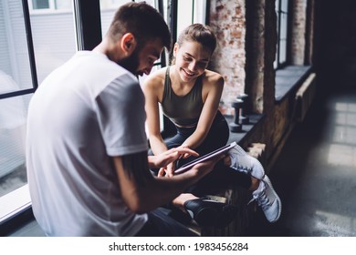 Smiling young woman watching content from social media on male's digital tablet having break on training, cheerful female and male athlete share media in blog keeping healthy lifestyle and shape - Powered by Shutterstock