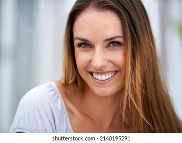 Smilling can be contagious. Portrait of a beautiful woman smiling at the camera.