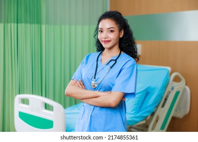 Smilling happy black female doctor standing in Recovery Room with beds and comfortable medical. Healthcare medical and medicine concept.