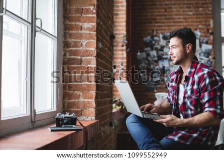 Smilling man using computer at home. Concept free people working at home. Freelancer.