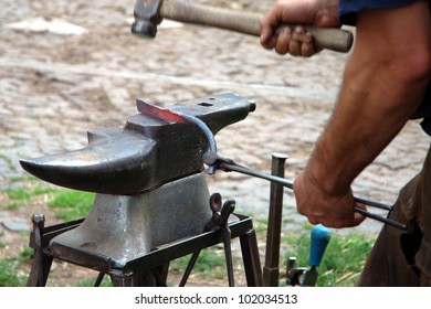 The smith forges a horseshoe (outdoors) - Powered by Shutterstock