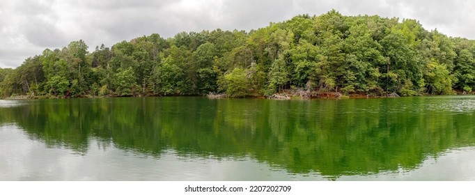 Smith Mountain Lake Virginia State Park Panorama Under Cloudy Sky With Trees And Lake Reflection.