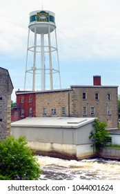 Smiths Falls, ON, Canada - June 14, 2015: The Town Of Smiths Falls With Its Water Tower On The Rideau River Is Experiencing An Economic Recovery Due To The Arrival Of Cannabis Producer Canopy Growth