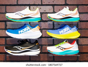 Smithtown, New York, USA - 28 August 2020: Six Running Shoes Are On Display On A Wall Of The Smithtown Running Company Shoe Store.