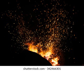 smithy fire flame tips with sparks closeup on dark background - Powered by Shutterstock