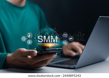 SMM, Social Media Marketing concept. Customizing profile page to give your customers the best visiting experience. Person use smartphone and laptop with SMM icon on virtual screen. 