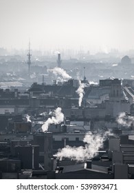 Smog - City Air Pollution. Unclear Foggy Atmosphere Polluted By Smoke Rising From The Chimneys In The Urban City Centre And Silhouettes Of Rooftops, Budapest, Hungary