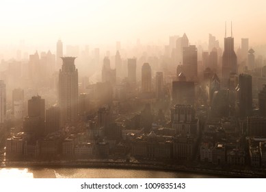 Smog lies over the skyline of Historical architecture and modern skyscraper on the bund of Shanghai city in misty sunrise, Shanghai, China vintage picture style - Powered by Shutterstock