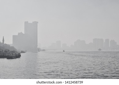 Smog in the polluted city - the embankment of the river Nile and the skyscrappers of Cairo, Egypt, in black and white