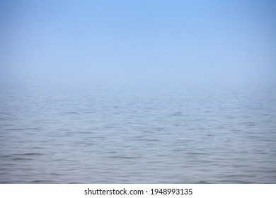Smoggy blurry mysterious fog in winter in front of blue waters of Palic Lake, in Subotica, Serbia. Also known as Palicko Jezero, it is one of the main attractions of Vojvodina province.

 - Shutterstock ID 1948993135