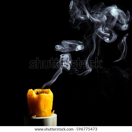 Smoke from blown out yellow candle