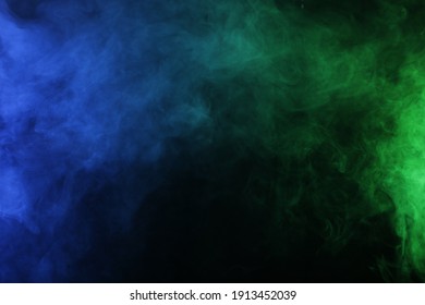 Smoke In Blue Green Light On Black Background In Darkness