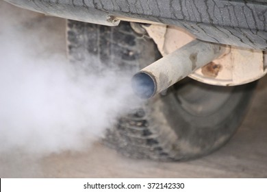 Smoke from car pipe exhaust. Old dirty car