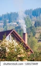 Smoke From Chimney Of House In Village