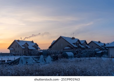 Smoke from the chimney of a suburban house on a winter morning. Heating houses in winter in the countryside. Concept of winter heating, country living and cozy houses. High quality photo - Powered by Shutterstock