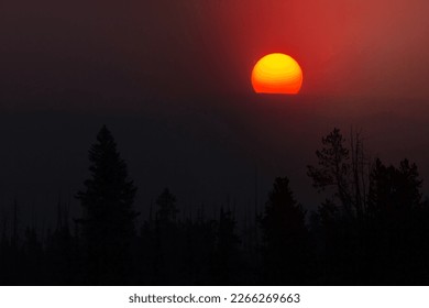 Smoke colors the sunrise over the Beartooth Plateau