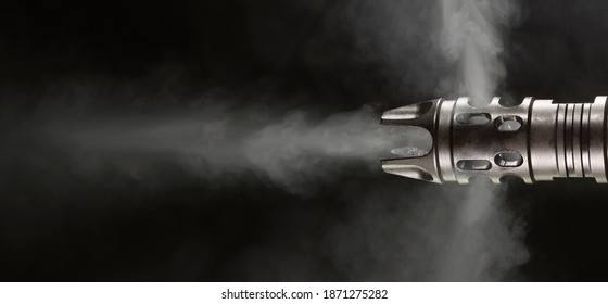 Smoke Coming Out Of A Muzzle Brake From An AR-15 On A Black Background