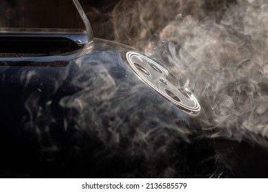 Smoke coming out from ventilation opening of a smoker grill. Round ventilation opening in open position to allow exit of smoke fumes. - Shutterstock ID 2136585579