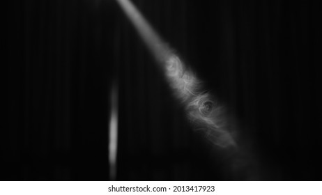 Smoke Cuts Through The Beam Of Light Coming From The Window.