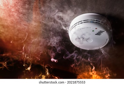 Smoke detector and fire alarm in action background with copy space - Shutterstock ID 2021875553
