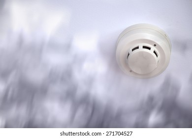 A Smoke Detector Installed At A Ceiling With Smoke