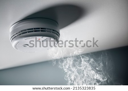 Smoke detector and interlinked fire alarm in action background with copy space Stock photo © 