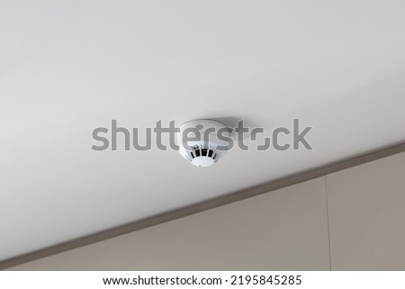 smoke detector mounted on plain ceiling, fire alarm system Stock photo © 
