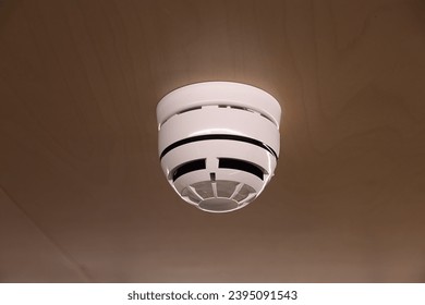 smoke detector on a ceiling. Stay home safe. Home control and security. - Shutterstock ID 2395091543