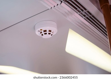 Smoke detector on ceiling in train, closeup of photo