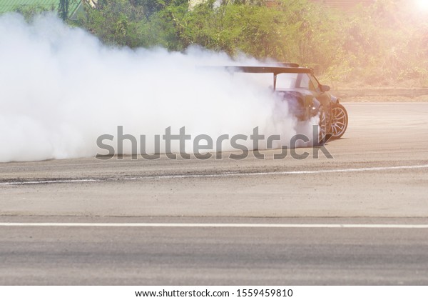 Smoke from drift\
car burning rubber wheel with motion speed motor sport racing.     \
                         