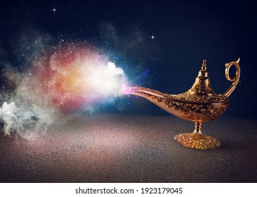 Smoke exists from magic aladdin genie lamp in a desert