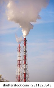 Smoke from the factory chimney. Environmental pollution. Air emissions polluting the city. Industrial waste is hazardous to health. - Shutterstock ID 2311325843