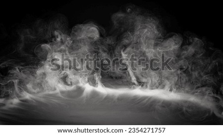 Smoke, fog or steam on black background flowing or rolling from center to edges