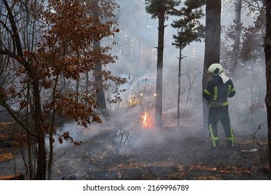 Smoke forest and fireman after forest fire silhouette. Selective focus