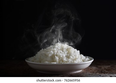 Smoke and hot rice in the plate 