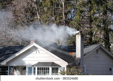 Smoke From House Chimney In Winter Day