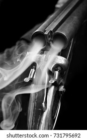 Smoke from a hunting double barrel vintage shotgun after firing.Comcept hunting.Closeup.Black and white