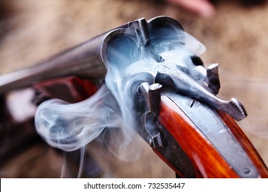 Smoke from a hunting double barrel vintage shotgun after firing.Comcept hunting.Closeup
