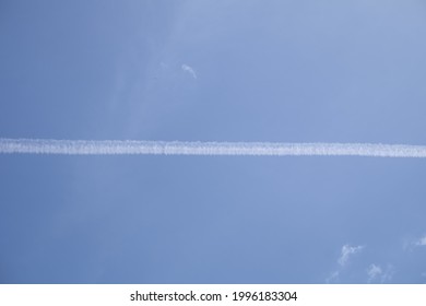 The Smoke Of A Jet Plane Against The Afternoon Sky.