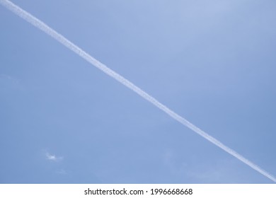 The Smoke Of A Jet Plane Against The Afternoon Sky.