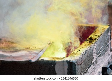 Smoke Molten Gold Being Poured Into Buddha Statue In Thailand.