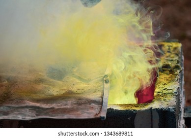 Smoke Molten Gold Being Poured Into Buddha Statue In Thailand.