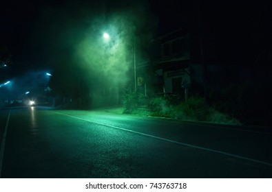 Smoke near street light on public road with old abandoned house background in Trang Thailand. Horror scene
