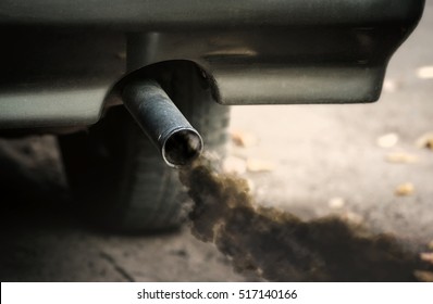 Smoke from old dirty car pipe exhaust.