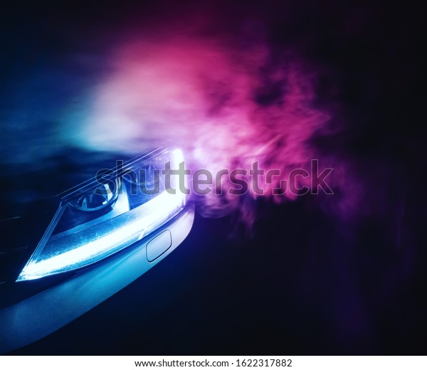 Smoke photography\
with car lights in the\
dark