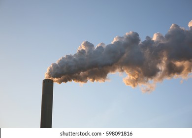 Smoke from pipes against the blue sky.