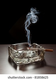 Smoke Rising From A Cigarette In An Ashtray.