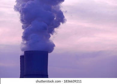 Smoke Rising From A Cooling Tower Of A Power Station, Red-violet Evening Sky, Concept Of Pollution, Energy Transition, Electricity And Climate Change