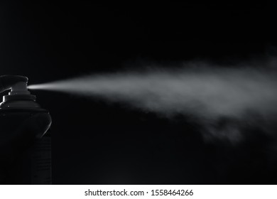 Smoke Spray Spit From Bottle On Left Side With Finger Pressing On Black Background.