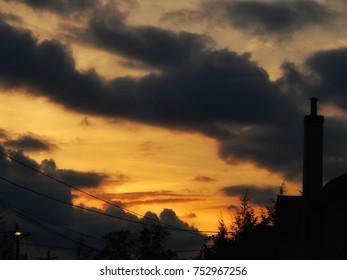 Smoke Stack Clouds And Sunset Over Cityscape